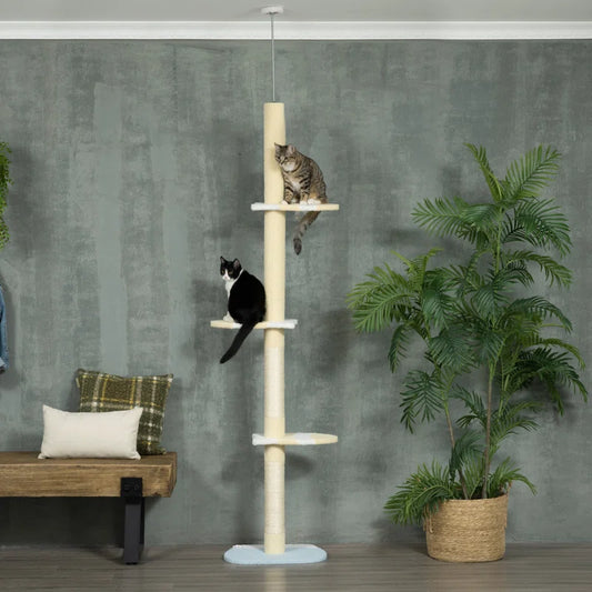 Cats playing on the floor to ceiling cat tree
